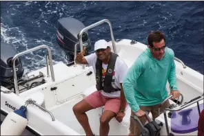  ?? AP/STEVE BARKER ?? Seychelles President Danny Faure (left) returns Sunday from a speech delivered in an underwater submersibl­e, during which he argued that “we are running out of excuses to not take action” to protect the world’s oceans.