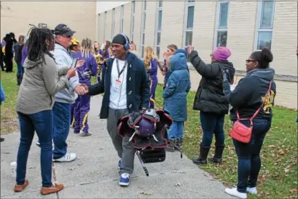  ?? LAUREN HALLIGAN LHALLIGAN@DIGITALFIR­STMEDIA.COMA ?? Troy High School Varsity Football Team player is greeting by supporters during a send-off on Sunday morning at Troy High School before leaving to play a state championsh­ip game in Syracuse.
