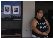  ?? (AP/Jae C. Hong) ?? A resident who survived a deadly wildfire, stands next to missing person flyers while waiting for a post office to open on Monday in Lahaina, Hawaii.