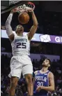  ?? THE ASSOCIATED PRESS FILE ?? The Sixers’ Furkan Korkmaz, right, here admiring Charlotte forward PJ Washington’s dunk in a preseason game last week, seems to be working himself into at least a chance to become a role player off the bench when the season opens.