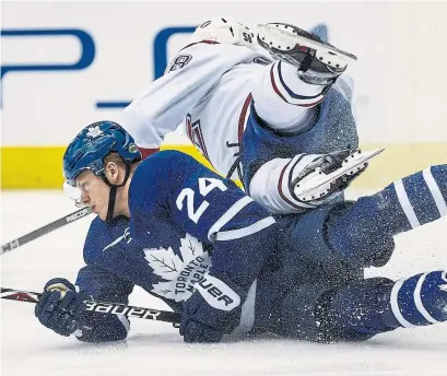  ?? BERNARD WEIL/TORONTO STAR ?? Leaf Kasperi Kapanen upends Mike Reilly of the Canadiens in Saturday night’s game at the Air Canada Centre.