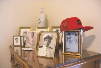  ?? Katie Falkenberg / Special to The Chronicle ?? Photos new and old adorn the dresser in the Medford, Ore., apartment of Ken Casanega.