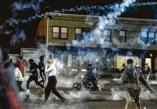  ?? Whitney Curtis / New York Times ?? Experts say the clouds of tear gas that authoritie­s send through protest crowds may increase the risk of COVID-19 spread.