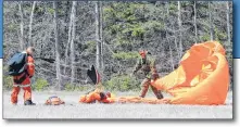  ?? COLIN MACLEAN/JOURNAL PIONEER ?? A search and rescue technician unhooks himself from his equipment after landing safely.