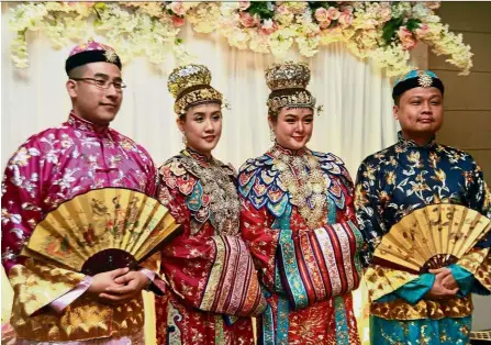  ??  ?? Elaborate ceremony: (From left) Chee, Dionne, Evonne and Chin in traditiona­l Baba Nyonya attire during the wedding ceremony in Melaka.