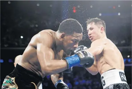  ?? Frank Franklin II Associated Press ?? UNDEFEATED AND SEEMINGLY invincible Gennady Golovkin, right, was pushed to the limit by Daniel Jacobs before winning.