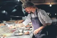  ?? Natacha Pisarenko, The Associated Press ?? Chef Nacho Trotta prepares plates at the restaurant he co-owns, Bestia, which uses fire- and wood-burning ovens in Buenos Aires, Argentina.