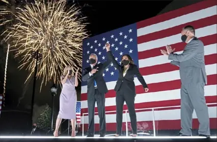  ?? Andrew Harnik/Associated Press ?? Democratic presidenti­al candidate Joe Biden and vice presidenti­al candidate Kamala Harris, with their spouses Jill Biden and Doug Emhoff respective­ly, celebrate Thursday during the Democratic National Convention.