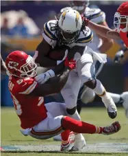  ?? AP PHOTO BY JAE C. HONG ?? Los Angeles Chargers running back Melvin Gordon, right, is tackled by Kansas City Chiefs linebacker Anthony Hitchens during the first half of an NFL football game Sunday, Sept. 9, in Carson, Calif.