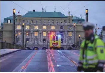  ?? ASSOCIATED PRESS ?? An ambulance drives Thursday toward the building of Philosophi­cal Faculty of Charles University in downtown Prague, Czech Republic. Czech police say a shooter at the school has killed at least 14 people and injured 25 more.