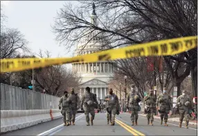  ?? Carolyn Cole / TNS ?? On the day before the presidenti­al inaugurati­on, troops guard the east side of the Capitol on Tuesday in Washington.