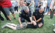  ?? Shelly Thorene /
Union Democrat ?? Sonora Police officers handcuff
Alexander Dylan Tischler, 30,
of Jamestown, who was filming the Freedom
Rally at Courthouse
Square.