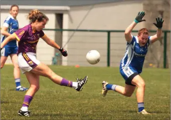  ??  ?? Fiona Rochford scores a point despite the best blocking attempt of Maggie Murphy from Laois.