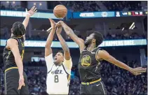  ?? JEFF CHIU — THE ASSOCIATED PRESS ?? Warriors forward Andrew Wiggins (22) blocks a shot by Utah Jazz forward Rudy Gay (8) during the second half in San Francisco on Sunday.
