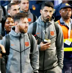  ??  ?? Messi (left) and Luis Suarez arrive alongside their teammates at OR Tambo Internatio­nal Airport in Johannesbu­rg. Barcelona are set to face Mamelodi Sundowns for the Nelson Mandela Centenary Cup match at the FNB Stadium in Johannesbu­rg. — AFP photo