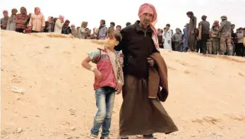  ??  ?? Syrian refugees cross into Jordan on Syria’s border, 320km north-east of Amman, just over a week ago.the commander of Jordan’s Border Guard Forces says the number of Syrian refugees waiting to enter has hit a high of 59 000.