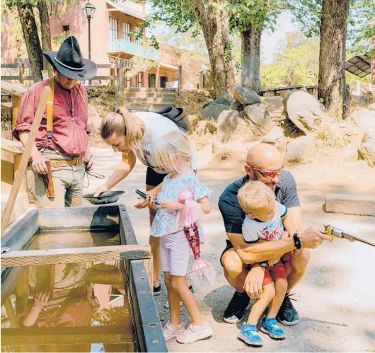  ?? JASON HENRY/THE NEW YORK TIMES ?? A family pans for gold Aug. 24 at California’s Columbia State Historic Park.