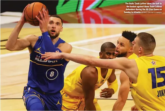  ?? KEVIN C. COX/GETTY IMAGES ?? The Bulls’ Zach LaVine takes the ball to the basket against three Team LeBron defenders during the All-Star Game on Sunday in Atlanta.