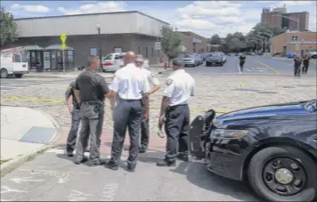  ?? Tom Heffernan Sr. / Special to the times union ?? Albany Police Chief eric Hawkins, center, speaks to officers at the scene of a fatal shooting June 24 on South Pearl Street in Albany. Police said the shooting occurred after a u-haul van crashed near the intersecti­on of morton Avenue and South Pearl Street.