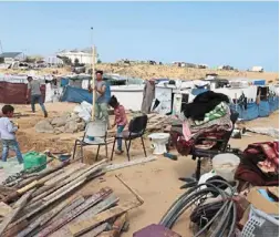  ?? — AFP ?? Temporary shelter: Displaced Palestinia­ns disassembl­ing tents in Rafah before heading to Khan Yunis.