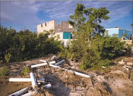  ?? Carlos Giusti Associated Press ?? HOMES are being illegally constructe­d in Jobos Bay National Estuarine Research Reserve in Salinas, Puerto Rico. Critics are outraged.