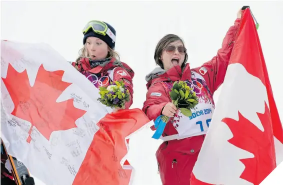  ?? ANDY WONG/THE ASSOCIATED PRESS ?? OH, CANADA Gold medallist Dara Howell, left, celebrates with bronze medallist Kim Lamarre.
