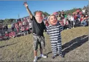  ?? REUTERS ?? Supporters of Donald Trump at a campaign rally in Naples, Florida, don masks of the Republican and his rival Hillary Clinton.