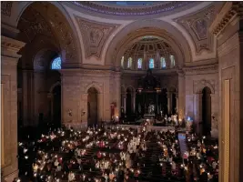  ?? GIOVANNA DELL’ORTO — THE ASSOCIATED PRESS ?? Hundreds of people light candles at the beginning of the Easter Vigil Mass at the Cathedral of St. Paul in St. Paul, Minn., on Saturday. For many U.S. Christians, this weekend marks the first time since 2019that they will gather in person on Easter Sunday, a welcome chance to celebrate one of the year’s holiest days side by side with fellow congregant­s.