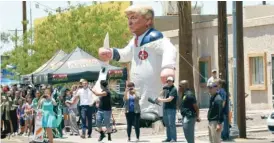  ?? AP ?? Protesters place a large balloon in the likeness of President Donald Trump dressed in a Ku Klux Klan sheet across the street from Southwest Key Campbell, a shelter for children who have been separated from their parents, in Phoenix, Arizona.