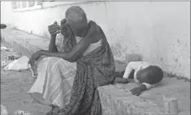  ?? SAMIR BOL / AGENCE FRANCE-PRESSE ?? A South Sudanese woman sits with a child on Wednesday at the main hospital in Bor, which troops loyal to President Salva Kiir reportedly recaptured from rebel forces.