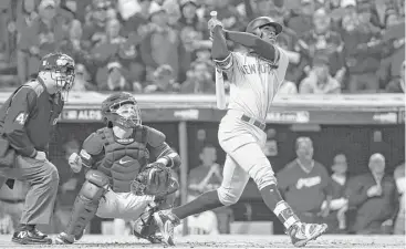  ?? Gregory Shamus / Getty Images ?? Shortstop Didi Gregorius connects on his first of two home runs against the Indians on Wednesday in Game 5 of the American League Division Series in Cleveland.