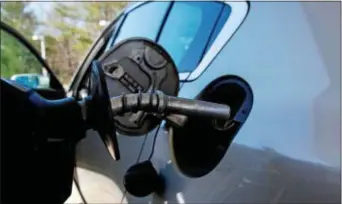  ?? CHARLES KRUPA — THE ASSOCIATED PRESS ?? In this photo, a car is filled with gasoline at a station in Windham, N.H. Crude oil prices are at the highest level in more than three years and expected to climb higher, pushing up gasoline prices along the way.