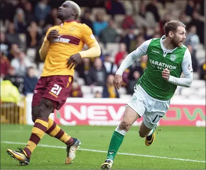  ??  ?? PREDATOR: Hibs’ Martin Boyle celebrates his goal, which he scored after a mistake by Motherwell’s Cedric Kipre (left)