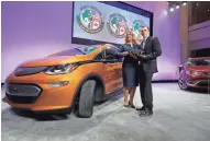  ?? ASSOCIATED PRESS ?? General Motors officials Pam Fletcher and Josh Tavel show off the Chevy Bolt Monday at the auto show in Detroit.