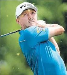  ?? NATHAN DENETTE THE CANADIAN PRESS ?? Mackenzie Hughes watches his tee shot on the forth hole during round one of the Canadian Open at the Glen Abbey Golf Club in Oakville on Thursday. He was later thwarted from finishing because of rain.