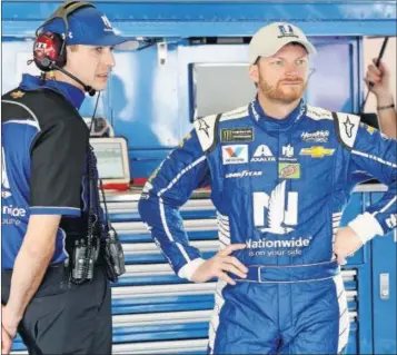  ?? JERRY MARKLAND] [NASCAR GETTY IMAGES/ ?? Dale Earnhardt Jr. with a crew member of his No. 88 Chevy inside the Daytona garage area.