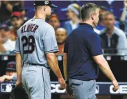  ?? Mark Brown / Getty Images ?? Cleveland starter Corey Kluber leaves in the fifth after his right forearm was broken on a liner.