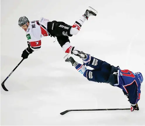  ?? Foto: dpa/Ronald Wittek ?? Auch die Fouls sind manchmal spektakulä­r: Hier wird Ronny Arendt (Adler Mannheim, r.) von Moritz Müller (Kölner Haie) zu Fall gebracht.