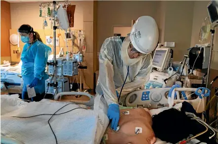  ?? AP ?? Dr Rafik Abdou checks on a Covid-19 patient at Providence Holy Cross Medical Centre in the Mission Hills section of Los Angeles.