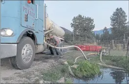  ?? ILIE MITARU – THE NEW YORK TIMES ?? Cody Joe Pearce, a sixth-generation rancher, fills up his water truck in Taylorsvil­le on Sept. 7. He started an ad-hoc community fire service.