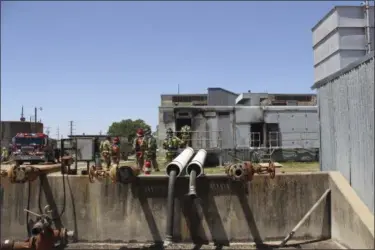  ?? BRYAN, TEXAS FIRE DEPARTMENT VIA AP ?? Bryan Texas firefighte­rs stand outside the Bryan Texas Utilities Power Plant following an explosion and fire. Earle Robinson, 60, and other employees were doing maintenanc­e work at Bryan Texas Utilities Power Plant, about 100 miles north of Houston,...