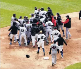  ?? AP PHOTO/NAM Y. HUH ?? Chicago White Sox and Cleveland Indians benches clear after a pushing incident at second base during the first inning on Thursday. All are wearing No. 42 in honor of Jackie Robinson Day.