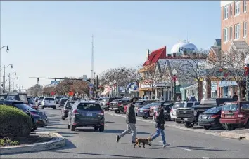  ?? Alex Brandon / Associated Press ?? Rehoboth Avenue is the main thoroughfa­re in Rehoboth Beach, Del. President-elect Joe Biden owns a $2.7 million home with a swimming pool that overlooks Cape Henlopen State Park, just blocks from the ocean and a short drive from downtown.