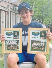  ?? ASHLEY SEDEROFF ?? Fourteen-year-old Torontonia­n Rory Sederoff holds photos of his previous summers at Camp Walden in New York state.