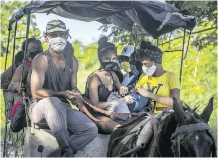  ?? (Photos: AP) ?? People wearing masks as a precaution against the spread of the new coronaviru­s travel to the beach in a horse cart in Havana, Cuba, on October 11, 2020.