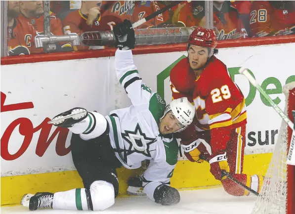  ?? — DARREN MAKOWICHUK ?? Flames forward Dillon Dube battles Dallas Stars counterpar­t Jamie Benn during Game 2 of their-first round playoff series on Thursday at Scotiabank Saddledome in Calgary. The Stars won 2-0 to even the series.