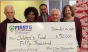  ?? ?? Karen Scott, second from left, executive director of First 5 San Bernardino, presents a check for $50,000 to Children’s Fund board members, from left, Gary Ovitt, Ciriaco “Cid” Pinedo, Neal Waner and Joyce Ablett. The funds augment Children’s Fund’s Celebratio­n of Giving toy drive to provide Christmas gifts for San Bernardino County children from birth to 5years.