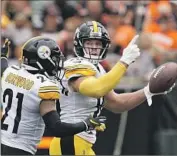  ?? Jeff Dean Associated Press ?? T.J. WATT of the Steelers gestures after making an intercepti­on before he left the game because of injury.