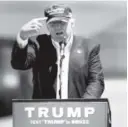  ?? Rich Pedroncell­i, The Associated Press ?? GOP presidenti­al candidate Donald Trump gestures to his “Make America Great Again” hat in June.