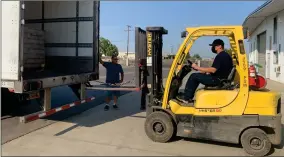  ?? RECORDER PHOTO BY ESTHER AVILA ?? PACC’S Fred Beltran helps Jonathan Martin, Portervill­e Shelter Workshop Life Coach II, unload 24 pallets of non-perishable food on Tuesday, Sept. 14, 2021. The food will be donated to Portervill­e nonprofits.